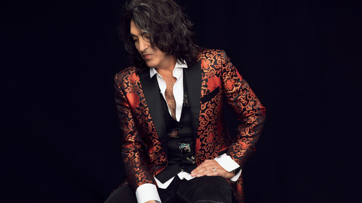 Paul Stanley sits in a flamboyant jacket to promote Soul Station